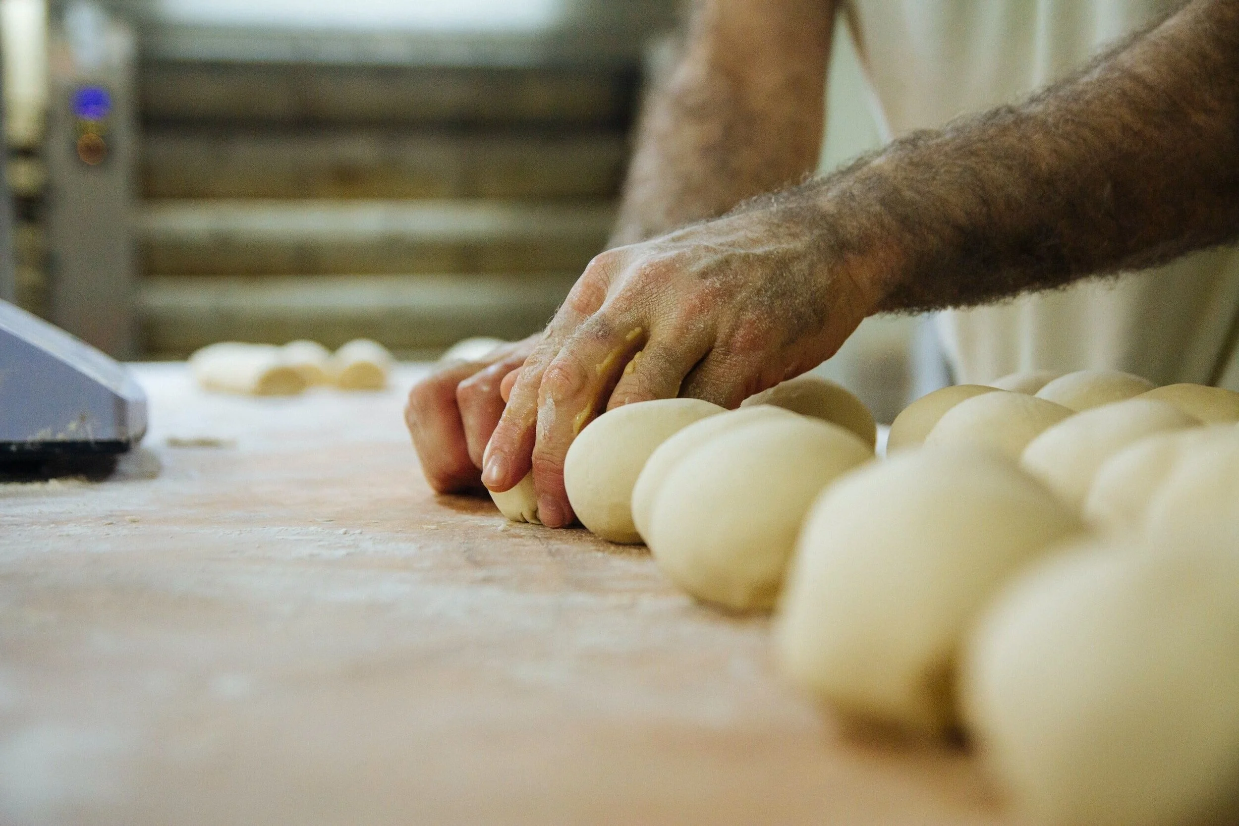 A Salt Spring Island baker shaping loaves of dough by hand